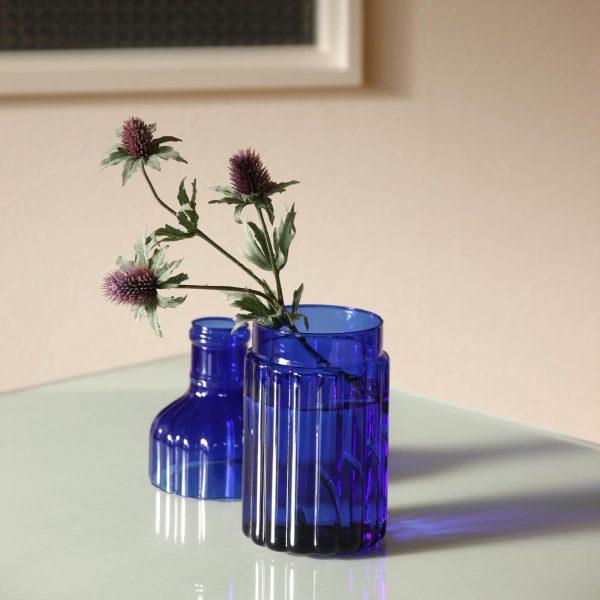 blue bottle vase with fresh flowers inside